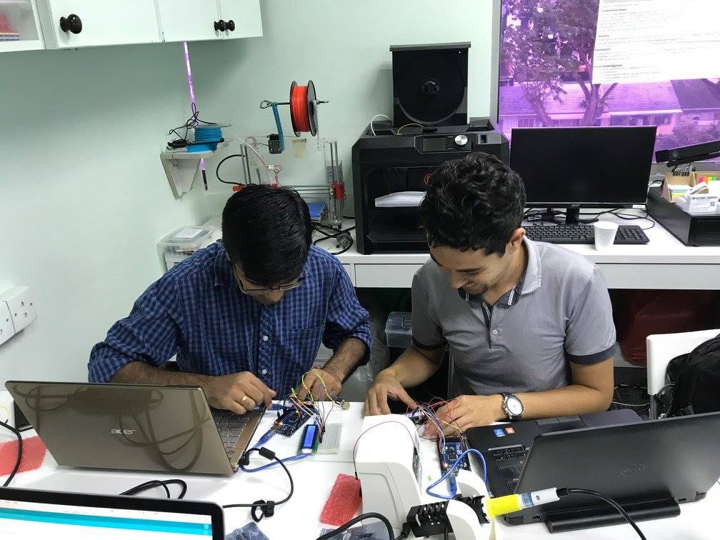 Two learners wiring Arduino boards and breadboards during the August 2017 class