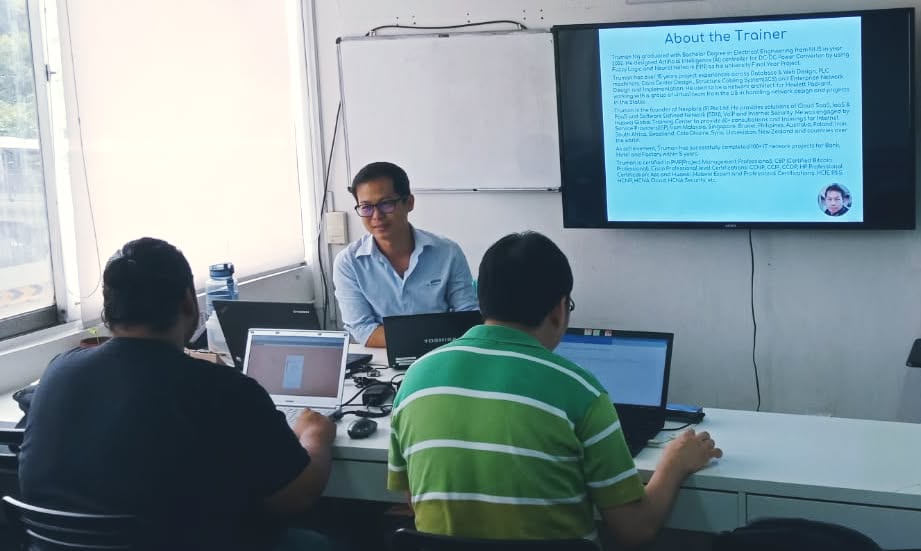 Trainer Mr Truman Ng presenting the About the Trainer slide to learners working on laptops at our 11 February 2020 Robotic Process Automation class in Singapore